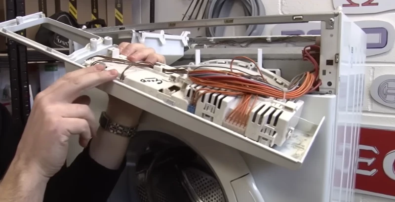 Technician repairing a washing machine during an appliance repair service call in Abilene, TX